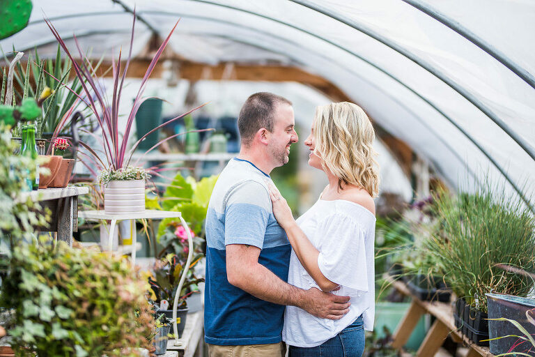 couple in greenhouse smiling Kaitlyn Ferris engaged 
