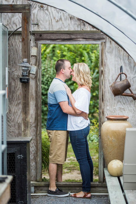couple in greenhouse doorframe Kaitlyn Ferris engaged 
