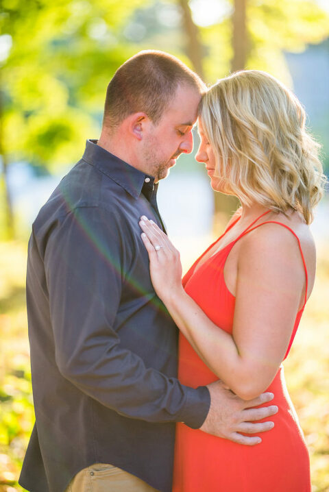couple holding each other red dress sun flare Kaitlyn Ferris engaged 