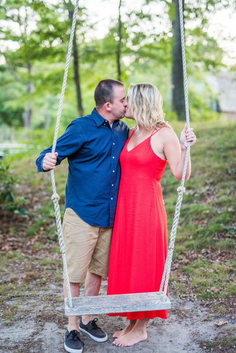 couple kissing on swing barefoot Kaitlyn Ferris engaged 