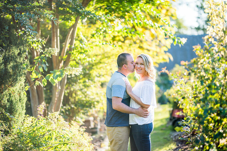 couple standing in greenery Kaitlyn Ferris engaged 