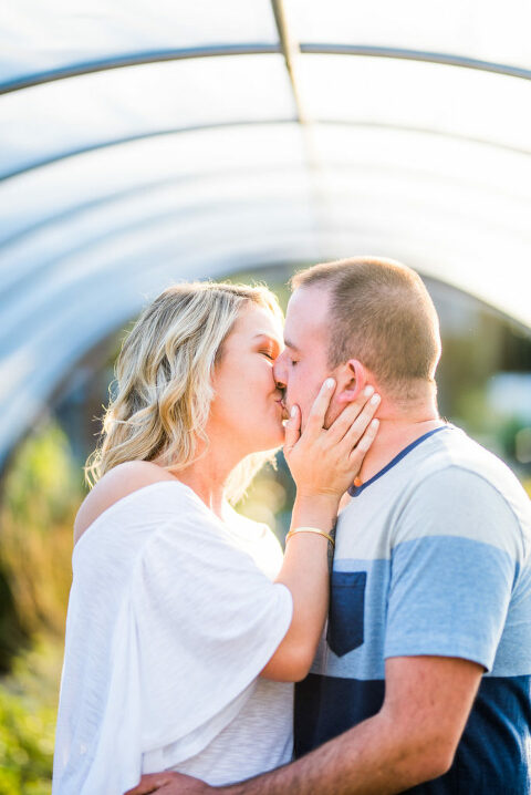 couple kissing in greenhouse Kaitlyn Ferris engaged 