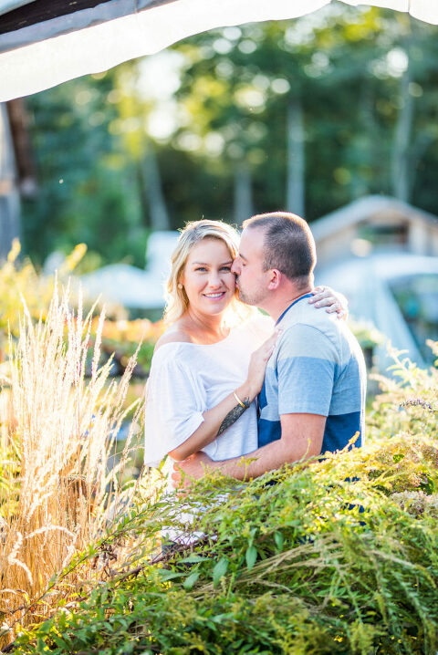 couple kissing in greenery Kaitlyn Ferris engaged 