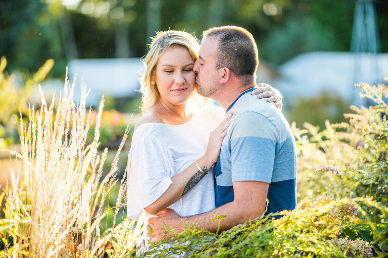 couple kissing in greenery Kaitlyn Ferris engaged 