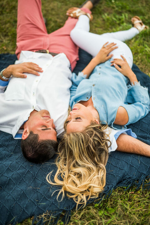 laying on a blanket romantic engagement