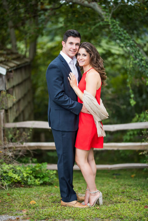 smiling at camera red dress summer engagement 