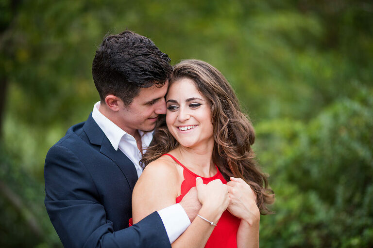 looking at each other red dress summer engagement 