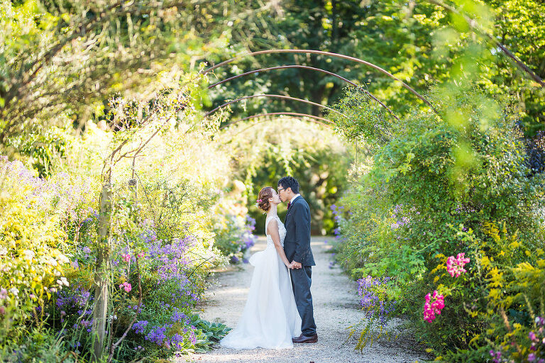 under a metal arbor Kaitlyn Ferris photography garden wedding