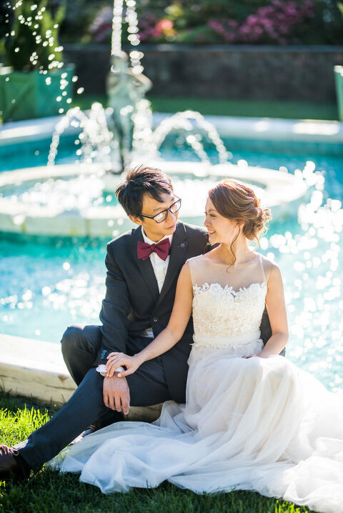 bride and groom by a fountain Kaitlyn Ferris photography garden wedding