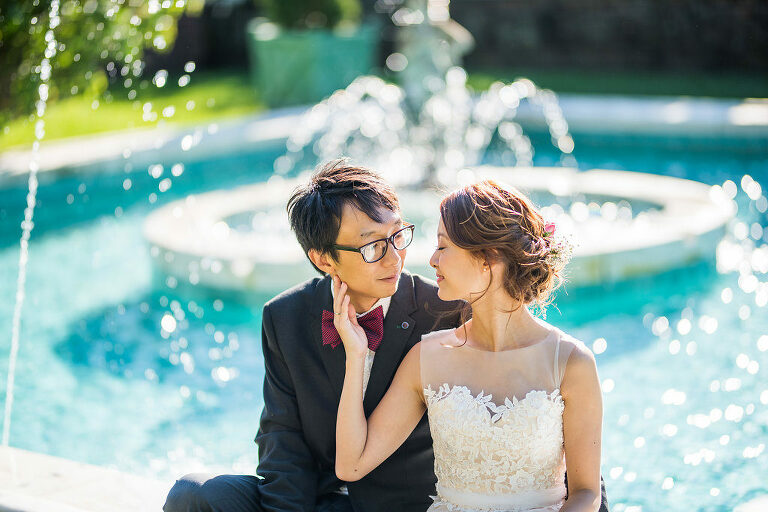 bride and groom sitting by a fountain Kaitlyn Ferris photography garden wedding