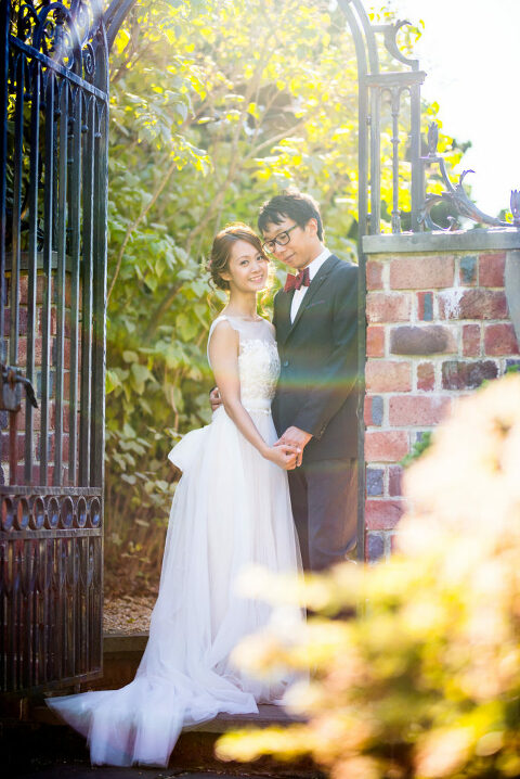 bride and groom under an arch way Kaitlyn Ferris photography garden wedding